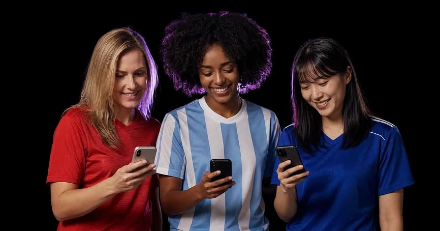 Three football fans in national-team jerseys shopping on their phones